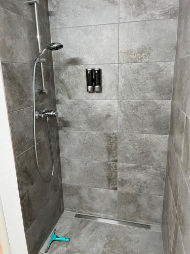 a shower in a bathroom with a glass door at Ferienwohnung LINA in Bitburg