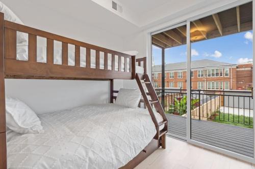 a bedroom with a bunk bed and a balcony at Capitol View2 Townhouse Condo in Washington, D.C.