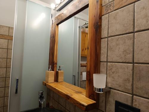a bathroom with a mirror and a sink at Sauze d'Oulx ciabot la garitüla with garden - wifi- close to the chairlift in Sauze dʼOulx