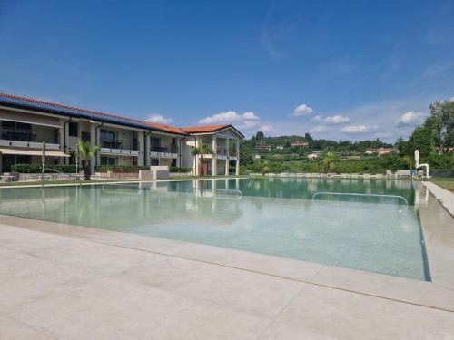 a large swimming pool in the middle of a building at Residence La Magnolia - Aparments in Lazise