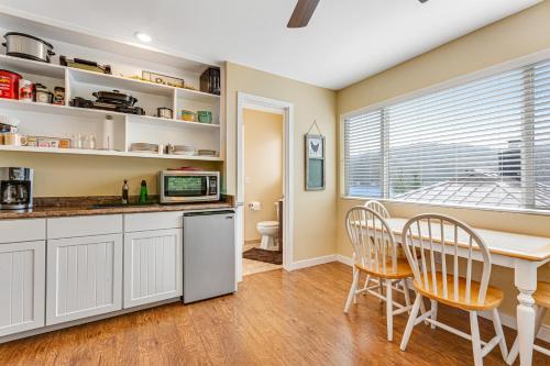 a kitchen and dining room with a table and chairs at Summit Lake Guesthouse in Kamilche