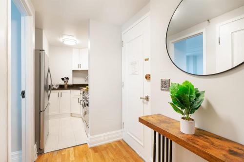 a kitchen with white walls and a mirror on the wall at 73-208 New 2BR 2BATH UWS Doorman Gym in New York