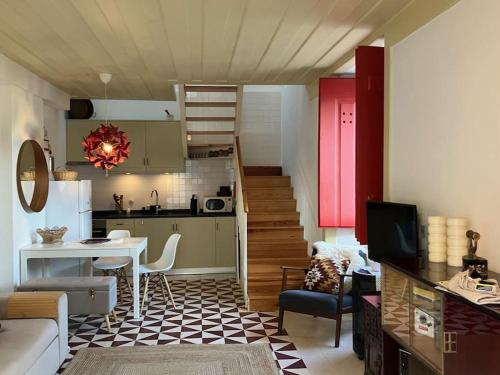 a living room with a kitchen and a dining room at Casinha de Sao Gião in Tomar