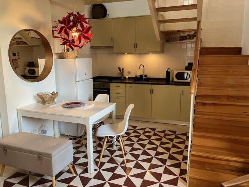a kitchen with a white table and a table and chairs at Casinha de Sao Gião in Tomar