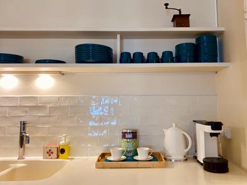 a kitchen counter with a tray with cups on it at ''Rooftop'' Superbe T3 quartier haut avec Rooftop privé! in Sète