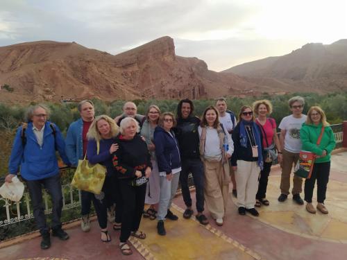 a group of people standing in front of a mountain at Maison D'hôte La Vallée Des Figues in Tamellalt