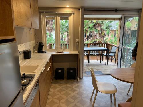 a kitchen with a table and a dining room at Rent Paradise in Grimaud