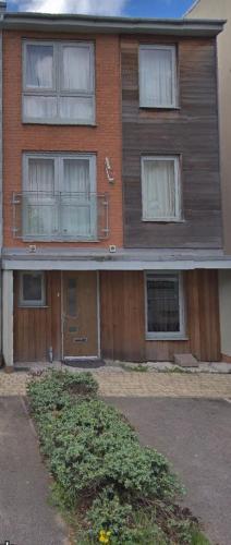 a house with a wooden door and windows at KO 3 bed house in Kent