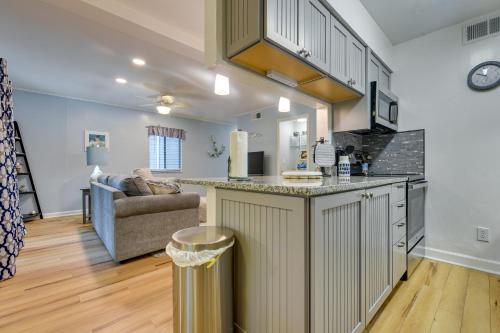an open kitchen and living room with a couch at Walkable Calabash Condo with Pool Access! in Calabash