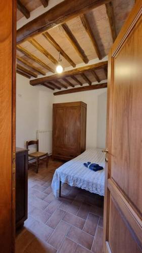 una camera con letto e soffitto in legno di Casa vacanze “La casetta di Anna” a Castel Viscardo