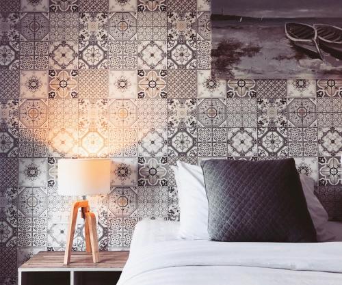 a bedroom with a bed and a wall with tiles at The Tamnan Pattaya Hotel & Resort in Pattaya North