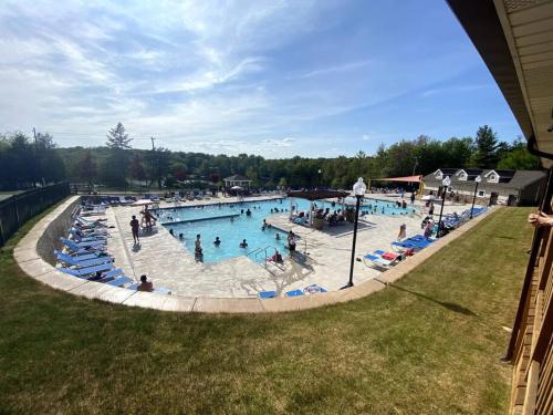 a large swimming pool with many people in it at Nature’s Haven:4 br/2.5 bath, game room & Fire pit in Tobyhanna