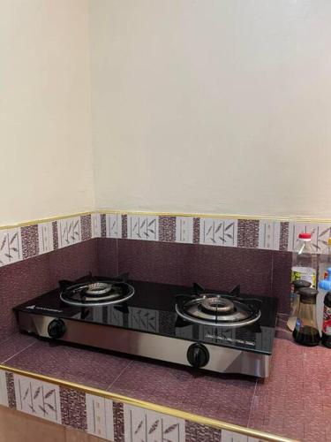 a kitchen with a stove top in a kitchen at ChemRald Guesthouse in Santander
