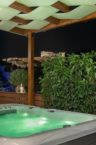 a green bath tub sitting under a wooden ceiling at Acropolis Divine Apartments in Athens