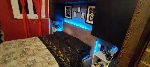 a bedroom with a bed with blue lights on it at Batman secret in Pontedera