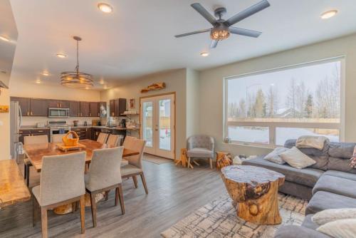 a living room with a couch and a table at Charming Family Haven On the Loop in Fairbanks