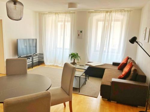 a living room with a couch and a table at Heart of Klosterneuburg in Klosterneuburg