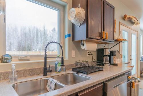 a kitchen counter with a sink and a window at Charming Family Haven On the Loop in Fairbanks