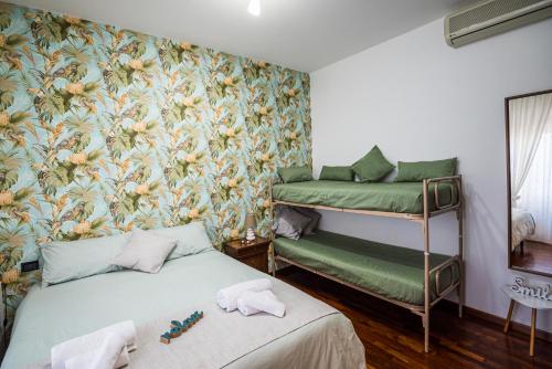 a bedroom with a bed and a floral wallpaper at Brigida B&B in Monteprandone