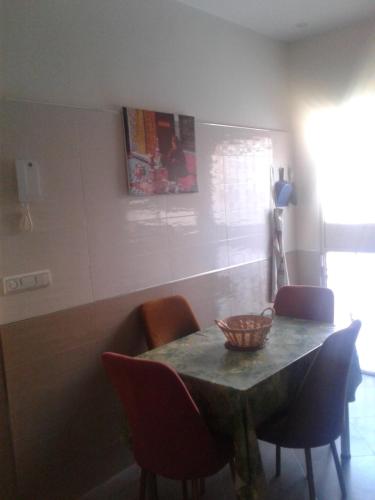 a dining room table with chairs and a bowl on it at Appartement meublé ennasr49 in Khenifra