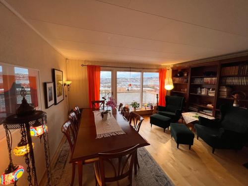 a living room with a table and chairs and a living room at Large house with spectacular view in Tromsø