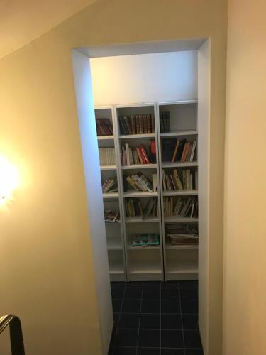 a room with a book shelf with books at Hotel César Centre-ville Gare Charleville-Mézières in Charleville-Mézières