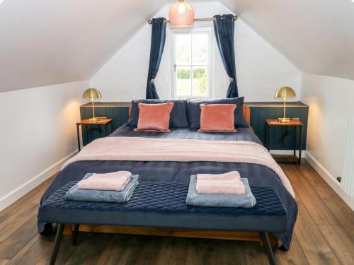 a bedroom with a blue bed with two pillows at Pensarngerrig in Llandysul