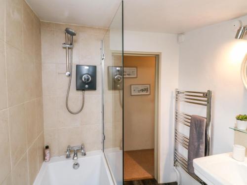 uma casa de banho com um chuveiro e uma banheira em Alexander's Cottage em Kingsbridge