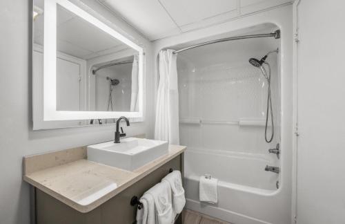a white bathroom with a sink and a shower at Camelot By The Sea 1206 in Myrtle Beach