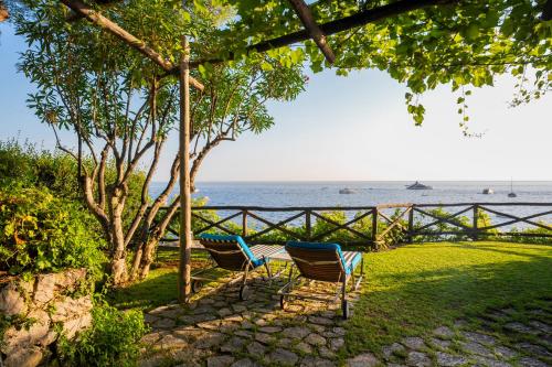 two chairs and a table in front of the ocean at Villa Treville in Positano