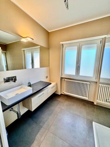 a bathroom with a sink and a large window at Seaside Suite in Civitavecchia