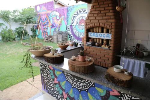 a patio with a table with pots and plants on it at Kasa Kaya in Araraquara