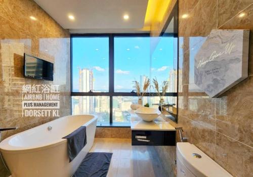 a bathroom with a tub and a large window at Dorsett Residence Kuala Lumpur 帝盛公寓 Bukit Bintang in Kuala Lumpur