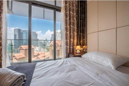 a bedroom with a bed and a large window at Dorsett Residence Kuala Lumpur 帝盛公寓 Bukit Bintang in Kuala Lumpur