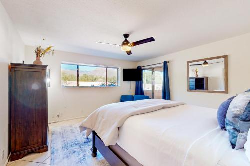 a bedroom with a bed and a ceiling fan at Sabino Canyon Hideaway in Tucson