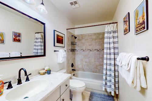 a bathroom with a tub and a toilet and a sink at Sabino Canyon Hideaway in Tucson