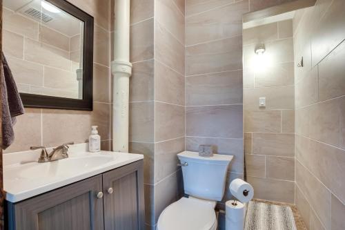 a bathroom with a toilet and a sink at Spacious Home in Ramsay 9 Smart TVs and Pool Table! in Ramsay