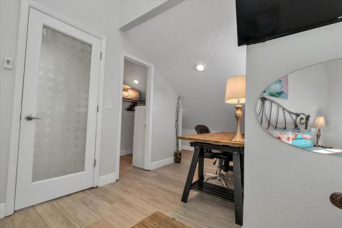 a room with a desk and a door with a mirror at Sneaky Tiki: Heated Saltwater Pool+5 min to beach in Largo