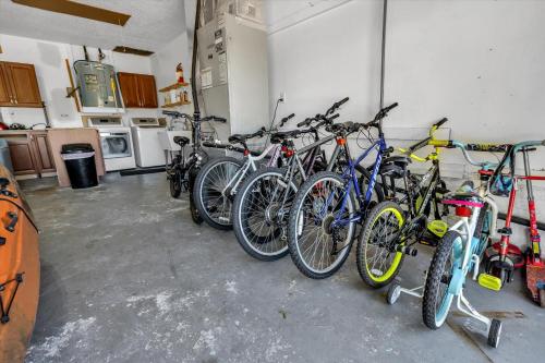 a group of bikes parked in a garage at Sneaky Tiki: Heated Saltwater Pool+5 min to beach in Largo