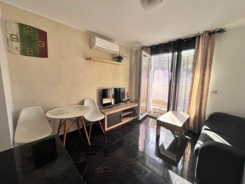 a small living room with a table and a tv at Edificio Sofia in Las Galletas