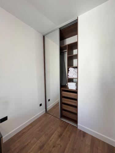 a bedroom with white walls and a closet at Kabaseo Spa in Becici