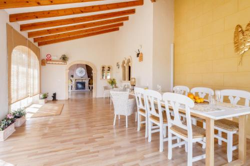 a kitchen and dining room with a table and chairs at Villa Gota de Mar in Jávea