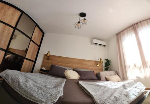 a bedroom with a large bed and a large mirror at Marelis condo with sea view in Ulcinj