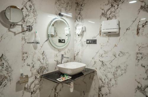 a bathroom with a sink and a mirror at Desert Heritage Resort & Camps in Jaisalmer