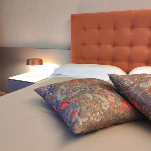 a bed with two pillows sitting on top of it at Casaalbergo La Rocca in Noale