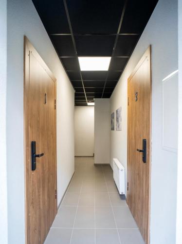 a hallway with wooden doors in an office building at Fort63 Studio in Kaunas