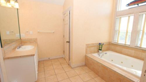 a large bathroom with a tub and a sink at OCEANFRONT, Ocean Views, Pool, Hot Tub, PI202, Turtle Key in Sanderling