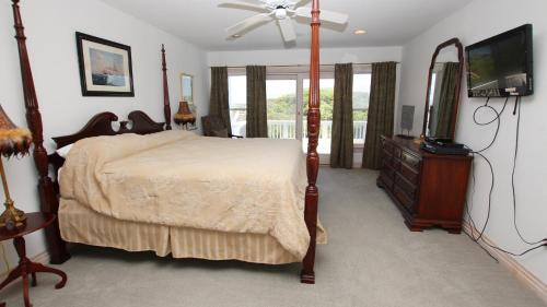 a bedroom with a bed and a flat screen tv at OCEANFRONT, Ocean Views, Pool, Hot Tub, PI202, Turtle Key in Sanderling