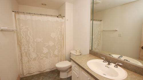 a bathroom with a sink and a toilet and a shower at OCEANFRONT, Ocean Views, Pool, Hot Tub, PI202, Turtle Key in Sanderling