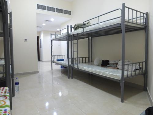 two bunk beds in a room with a hallway at B&B Hostel in Dubai